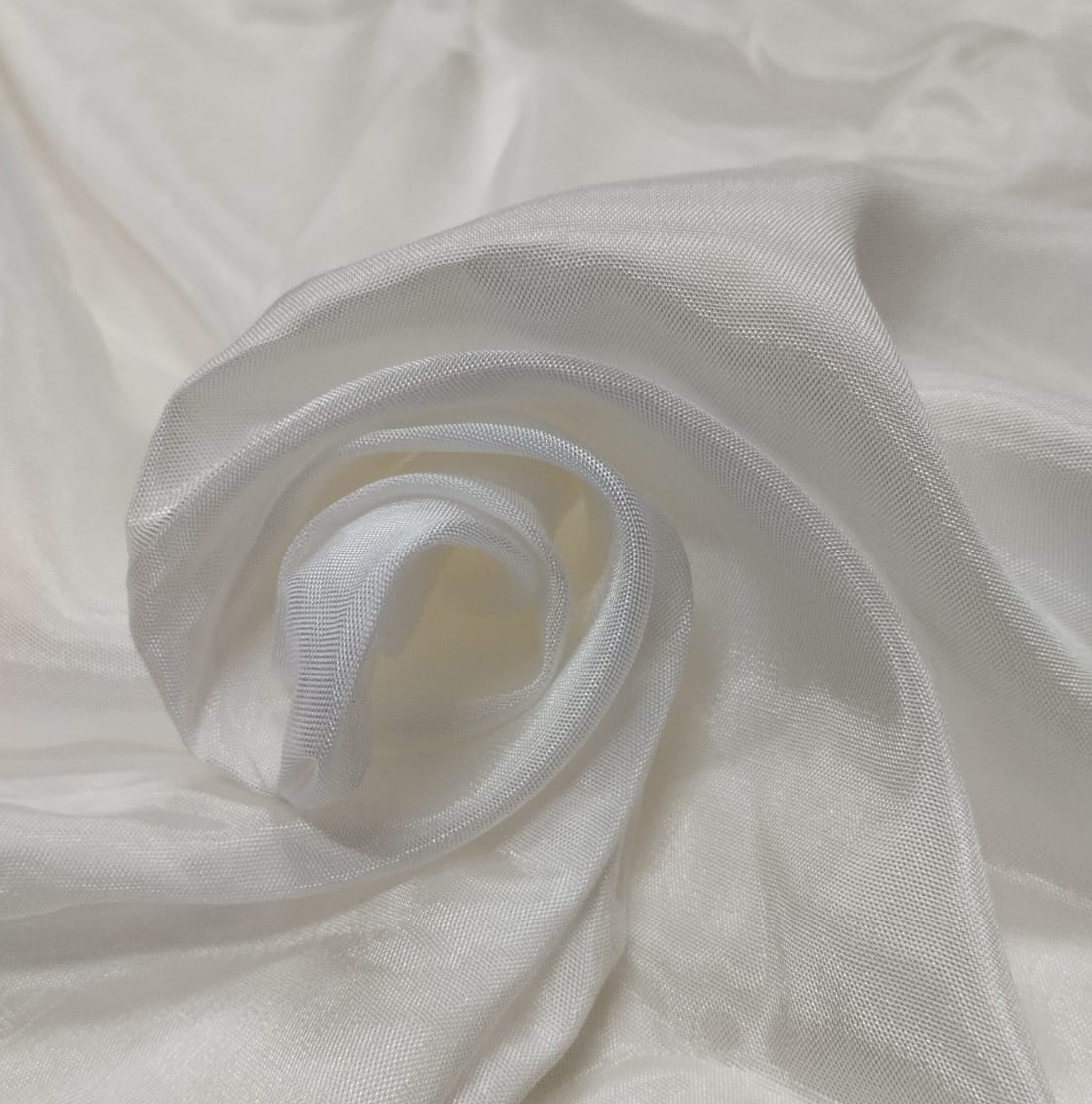 Soft white Audi fabric with a lightweight sheer texture and elegant shine ideal for dresses, sarees, dupattas, and designer garments.