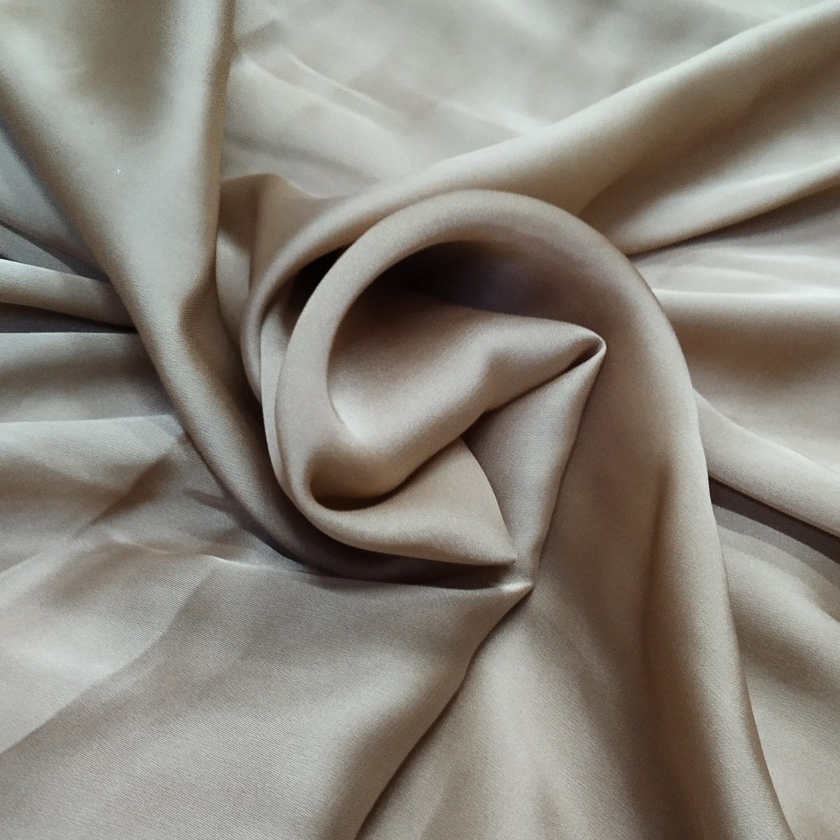 Taupe beige satin fabric with a smooth silky texture and elegant flowing drape.