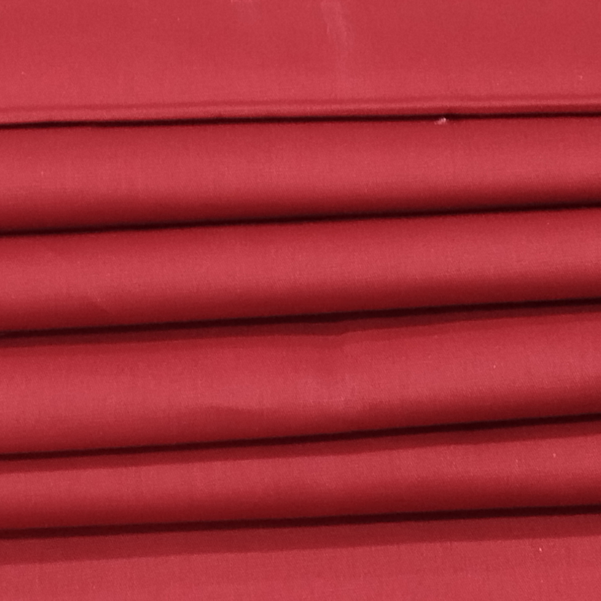 Soft dyed red Kiwi Cotton fabric with a smooth breathable texture ideal for kurtis, dresses, shirts, and casual wear.