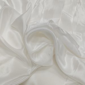 Soft Natural Crepe fabric with a textured surface, fluid drape, and elegant matte finish suitable for dresses and ethnic wear.