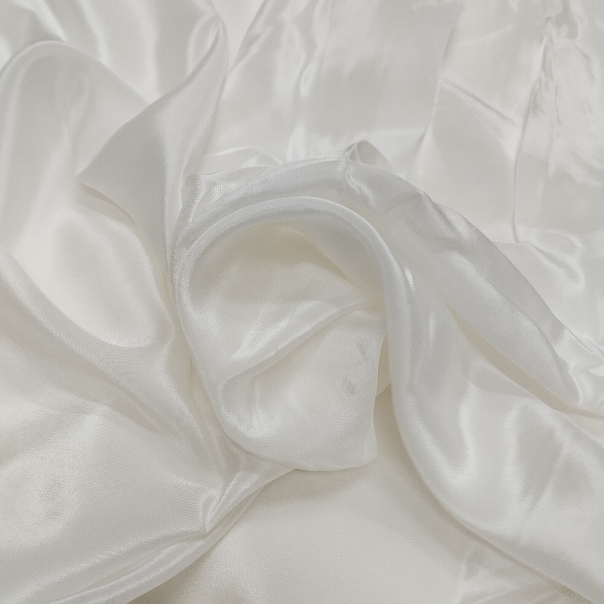 Soft Natural Crepe fabric with a textured surface, fluid drape, and elegant matte finish suitable for dresses and ethnic wear.
