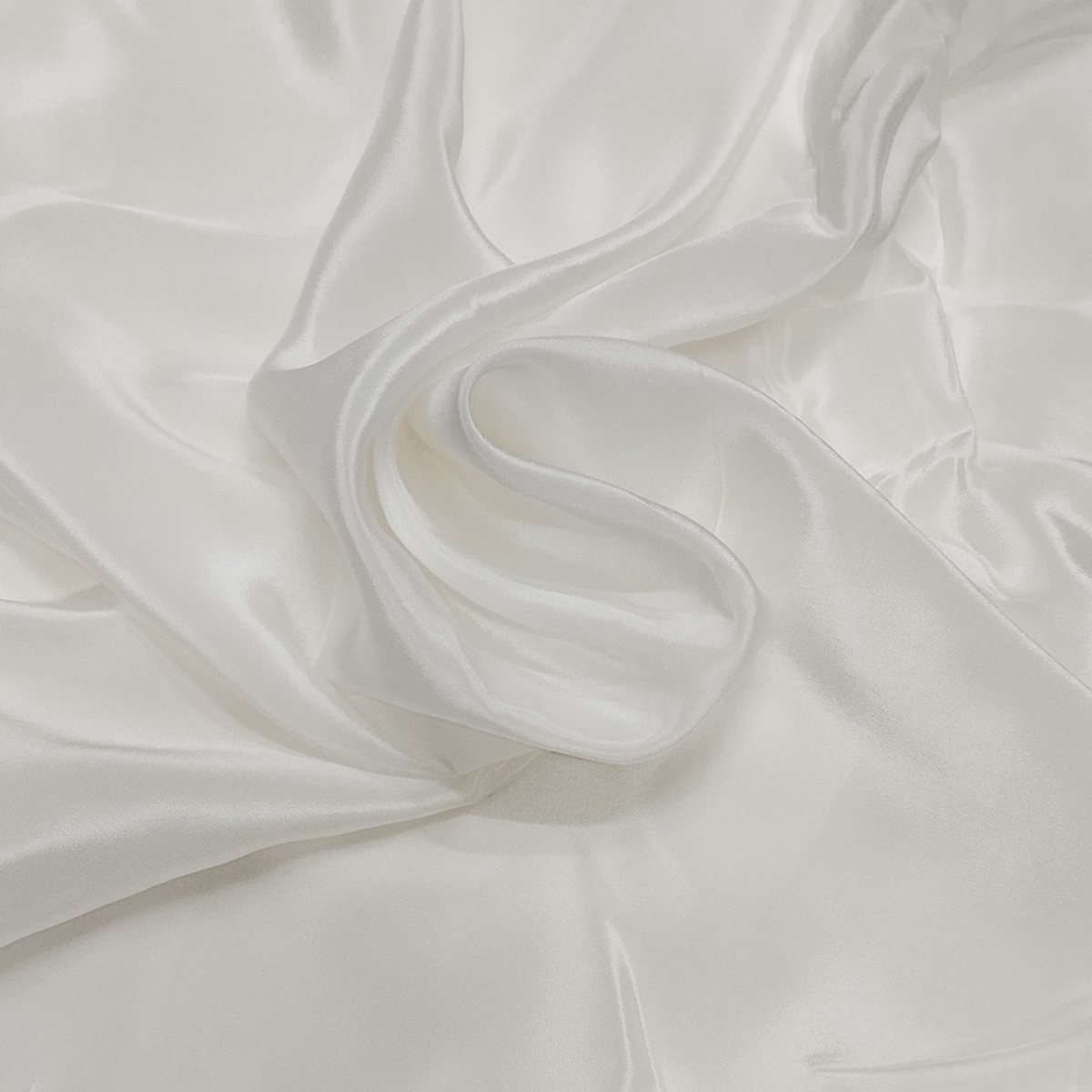 Natural Crepe fabric with a textured surface, fluid drape, and elegant matte finish suitable for dresses and ethnic wear.