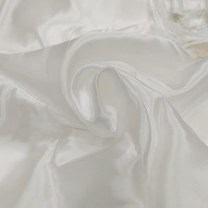 White dyeable Candy Silk fabric with smooth glossy texture and elegant flowing folds.