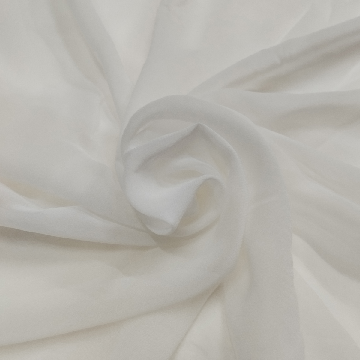 Soft white dyeable georgette fabric with lightweight semi-transparent texture and elegant flowing drape