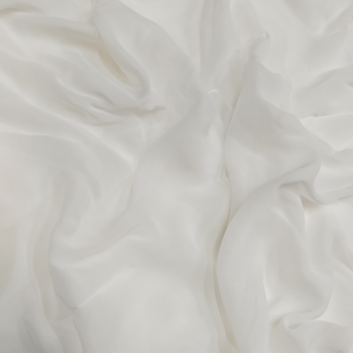 Soft white dyeable georgette fabric with lightweight semi-transparent texture and elegant flowing drape