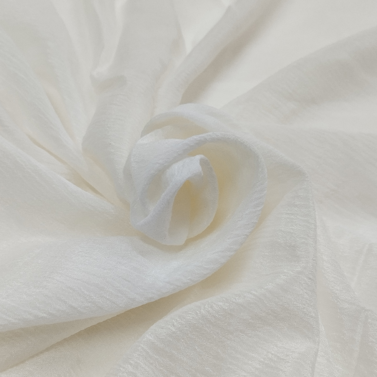 Mango Crush fabric with textured crushed pattern, soft lightweight feel, and elegant flowing drape for designer outfits.
