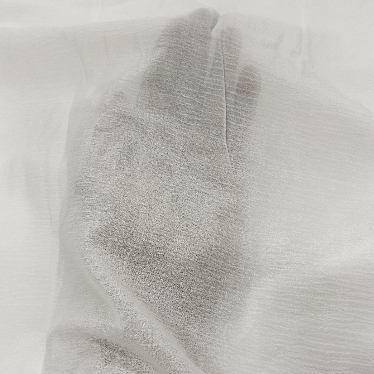 Mango Crush fabric with textured crushed pattern, soft lightweight feel, and elegant flowing drape for designer outfits.