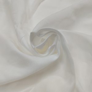 Soft white muslin dull fabric with lightweight texture and matte finish displayed in elegant folds.