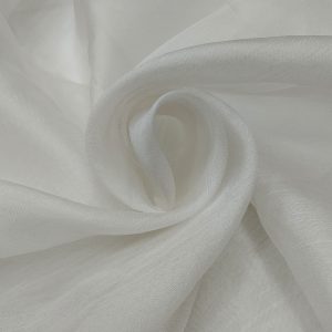 Pure organza tissue gold fabric with soft shimmer and transparent lightweight texture arranged in elegant swirl folds.