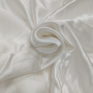 Premium white raw silk satin fabric with smooth glossy texture and luxurious flowing drape.