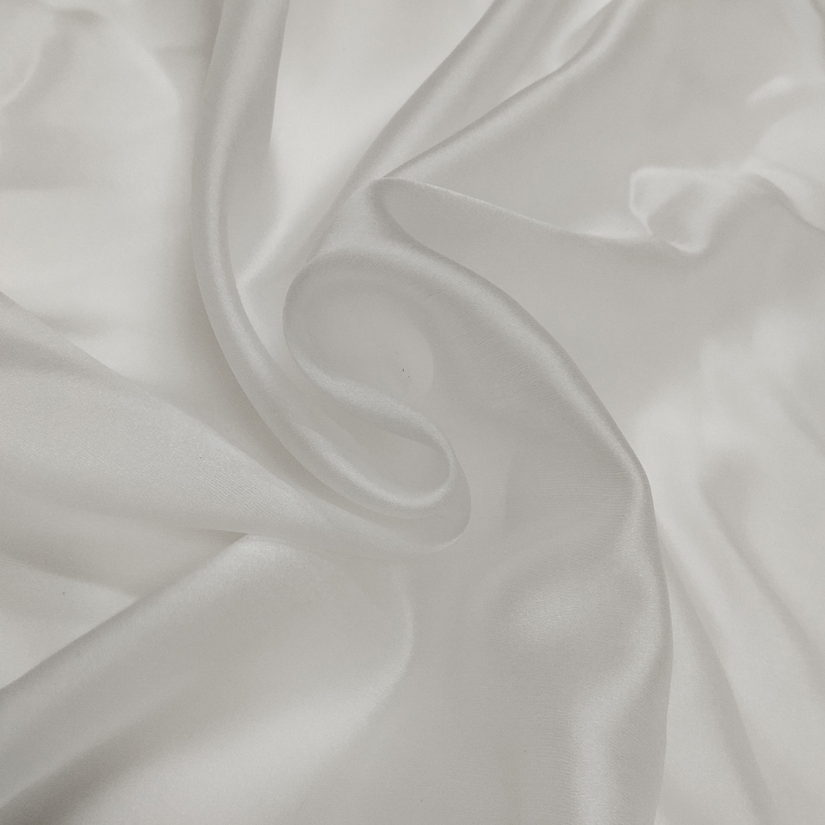 Elegant Satin Organza fabric with a glossy finish, sheer texture, and lightweight crisp drape for designer and festive wear.
