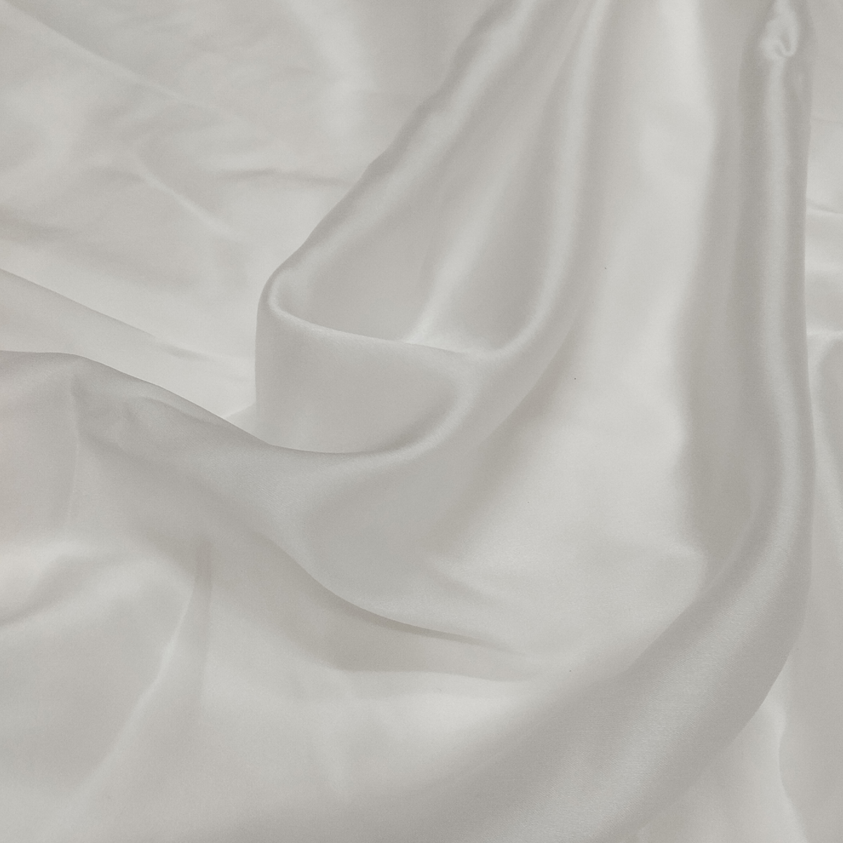 Elegant Satin Organza fabric with a glossy finish, sheer texture, and lightweight crisp drape for designer and festive wear.