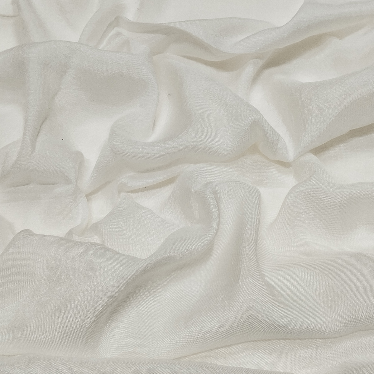 Premium ivory taffeta fabric arranged in swirl pattern